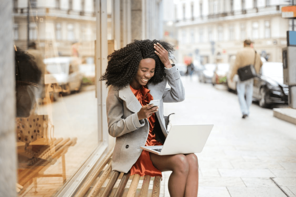 A business owner working with cloud-based computing outside a cafe