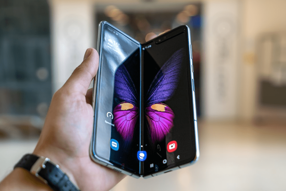 A person holding a foldable phone