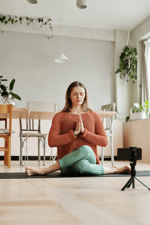 a woman meditating on the floor